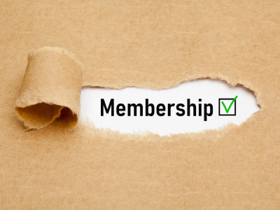 The word Membership with green verification check mark appearing behind torn brown paper.